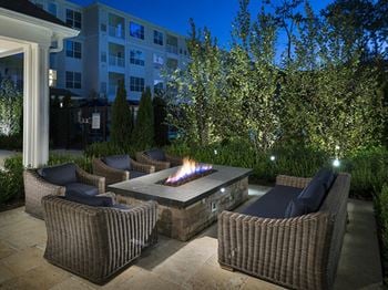 Expansive lawn with lounge seating that includes games and dual fireplace